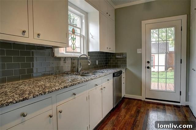 Close-up of kitchen details including glass subway tile backsplash and built-in shelving
