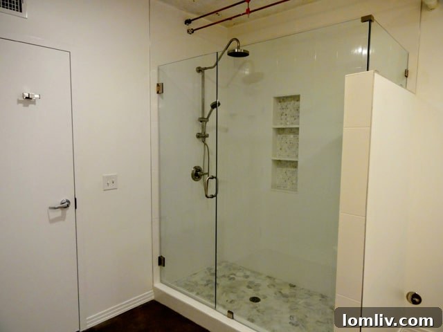 Luxurious seamless glass showers in the modern bathrooms of Suite 200