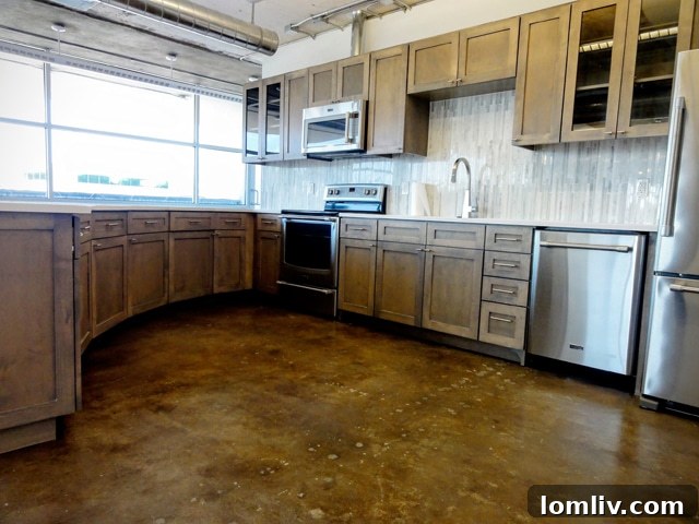 Contemporary kitchen cabinets and ample storage in Suite 200 of a Dallas live/work loft