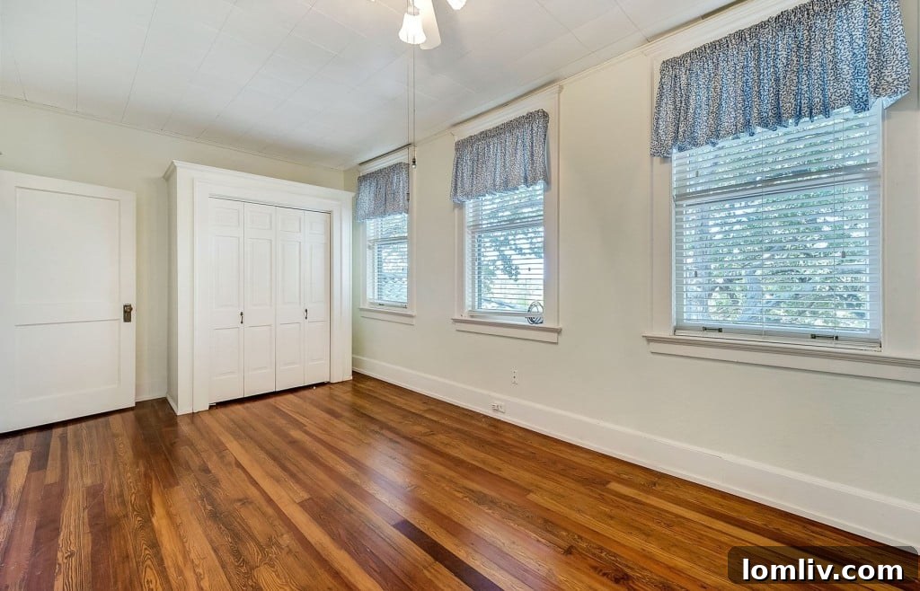 Mystical Allure of Mistletoe Heights Historic Villa 19 Cozy Guest Bedroom with Natural Light and Views of the Lush Property