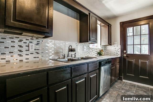 An unfinished kitchen backsplash above a sink, missing several tile panels