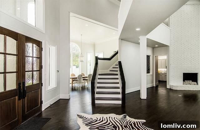 Elegant Entryway with Hardwood Floors - Preston Forest Remodel