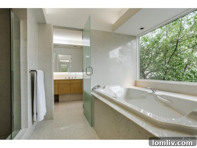 Bluffview Contemporary: An Illuminated Realm of Expansive Design 9 Luxurious Master Bathroom with Jetted Tub and Views
