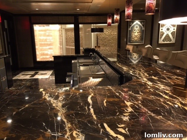 The exquisite Michelangelo marble bar at The Stoneleigh Residences, a focal point of luxury.