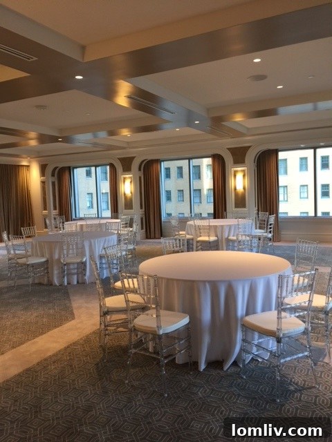 The luxurious ballroom at The Stoneleigh Residences, set with elegant tables and chairs for a grand event.