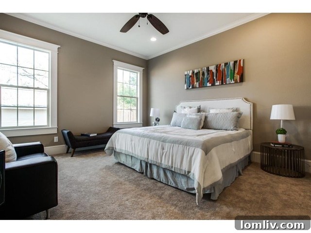 Spacious master bedroom with abundant natural light from large windows