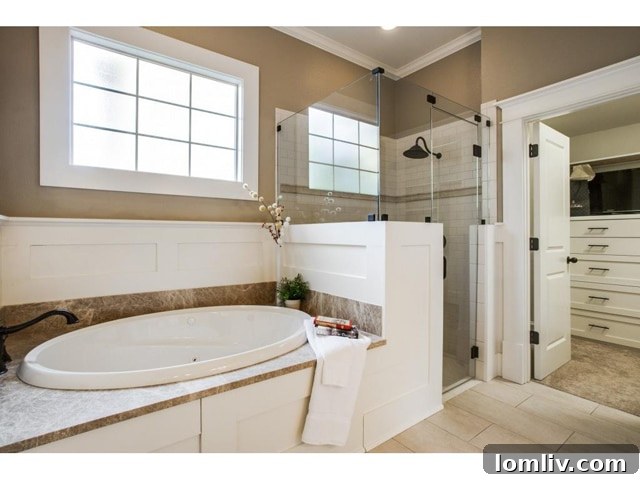 Luxurious master bathroom with dual vanities, jetted tub, and separate shower