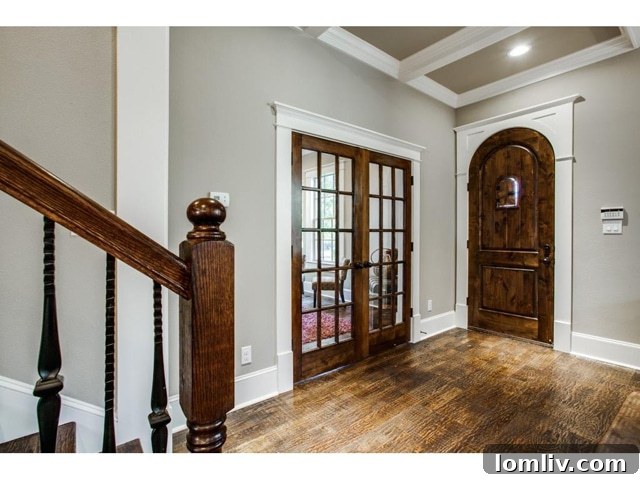 Elegant foyer with dark hardwood floors and white trim at 1117 Kings Highway