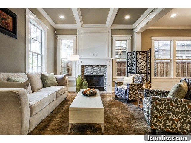 View of the living room with contemporary furniture and French doors to an office