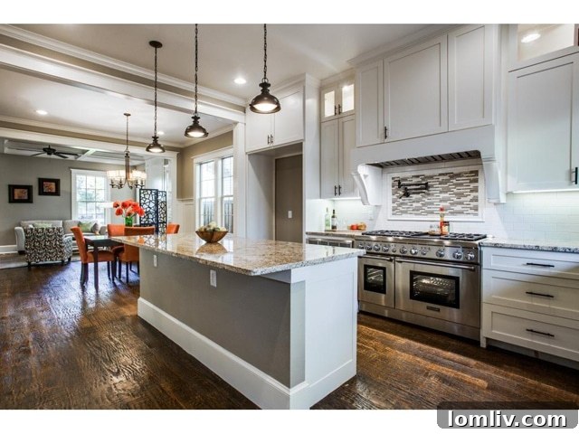 Modern kitchen with large granite island, Viking range, and custom cabinetry