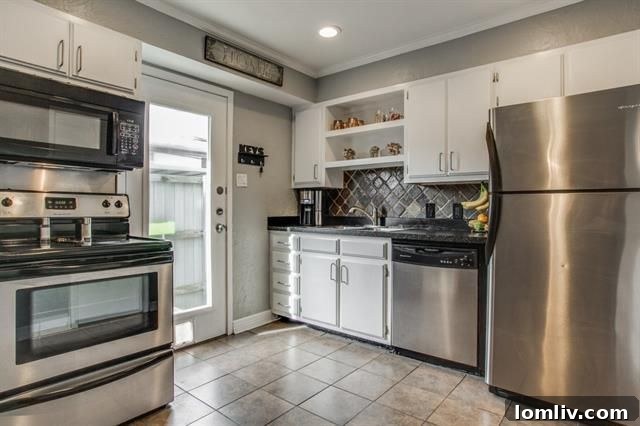 Clean and functional updated kitchen with a view towards the dining area, showcasing the open floor plan.
