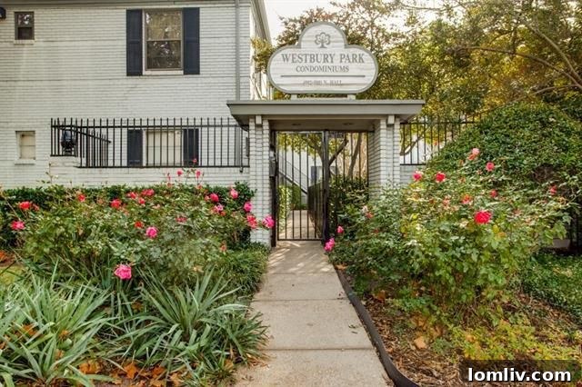 Bright red door of a Westbury Park condominium, surrounded by lush green foliage and well-maintained brickwork.
