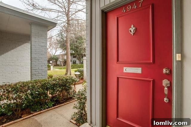 Exterior shot highlighting the well-maintained facade of a Westbury Park condominium, with mature landscaping and a welcoming red door.
