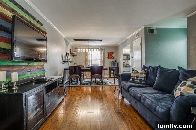 Cozy living room with hardwood floors and ample natural light, showing an inviting and updated interior.