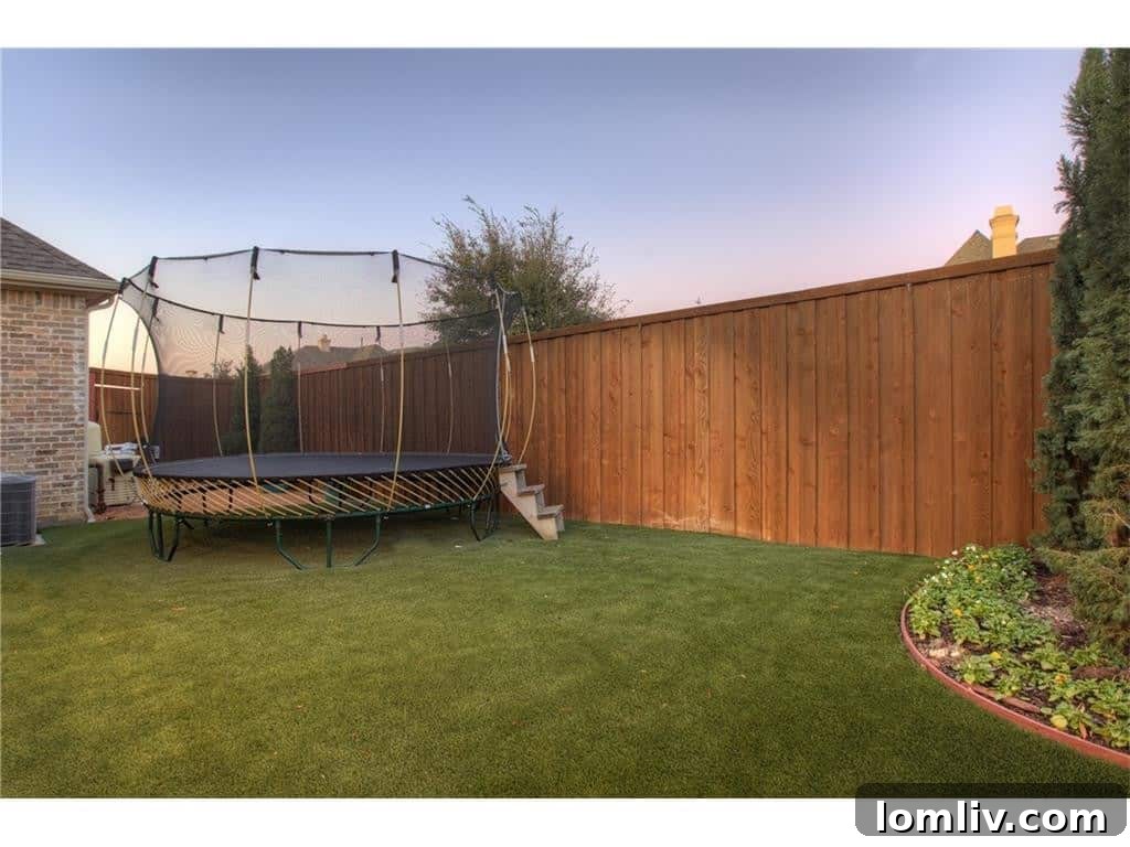 Integrated trampoline and turf area in the backyard, catering to active lifestyles.