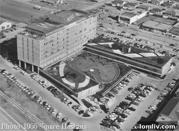 Historical photo of The Meadows Building from 1955, illustrating its original architectural design before subsequent modifications.