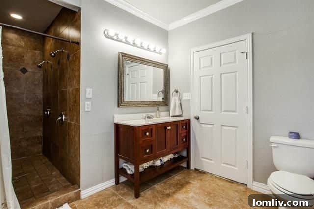 Pedestal sink and new tile in updated second bathroom