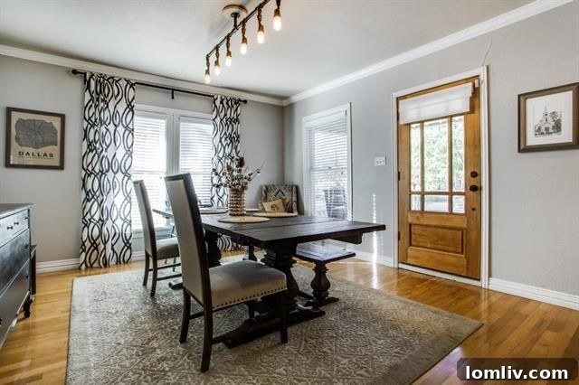 Spacious dining area with archway in Craftsman bungalow
