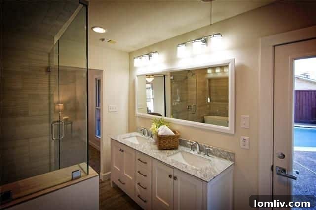 Luxurious master bathroom with dual sinks, glass shower, and garden tub