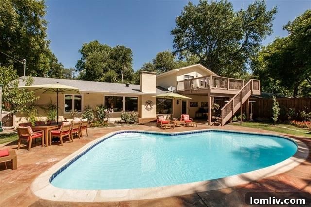 Spacious second-floor living area opening to a large deck overlooking the pool