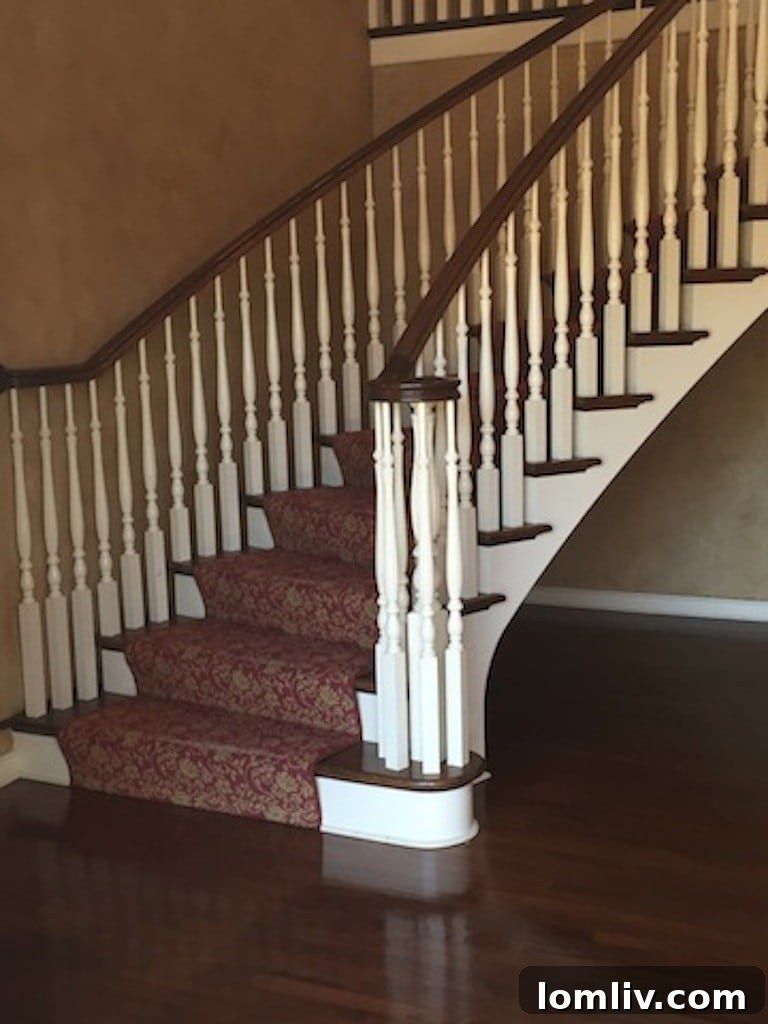 Elegant Foyer with Polished Hardwood Floors and Curved Staircase