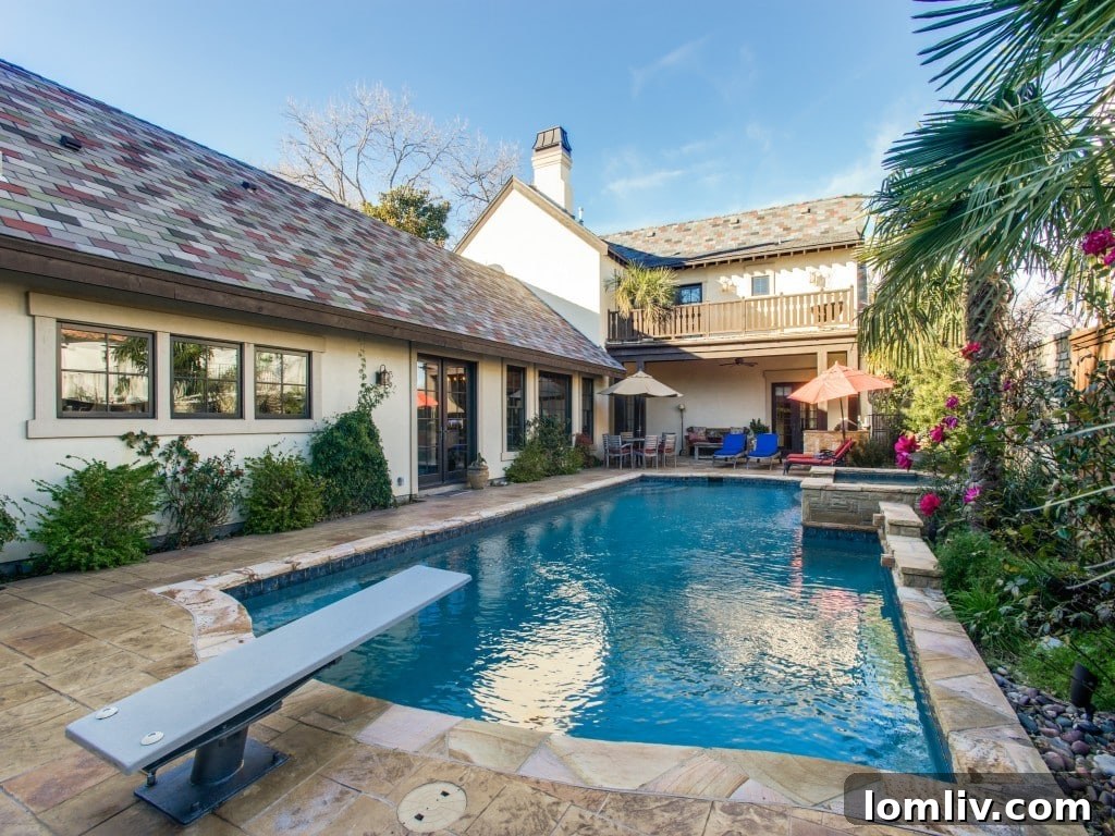 Expansive view of the backyard and pool area at 6832 Avalon Ave, Dallas TX, highlighting the lush landscaping and ample space for outdoor activities.