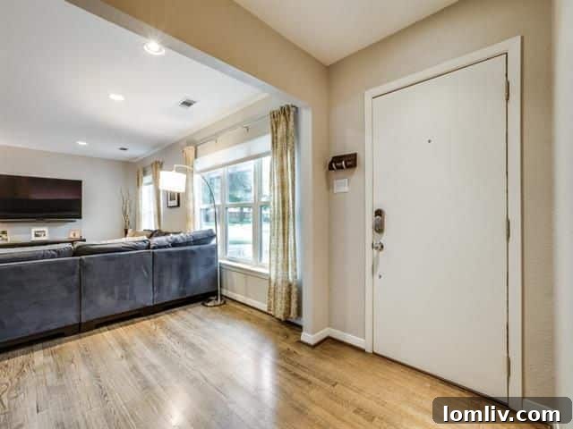 Modern kitchen with large island, granite countertops, and white cabinets at 6108 Town Hill Ln