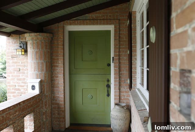 Explore Charles Dilbeck's Iconic Designs in the Cochran Heights Home Tour 4 The welcoming front entry of the Dilbeck home at 5106 Milam, featuring intricate woodwork and historical charm, inviting visitors into its unique interior.