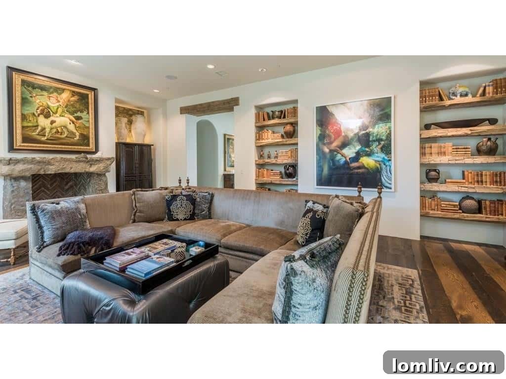 Elegant family room with a rustic fireplace and wide plank wood floors