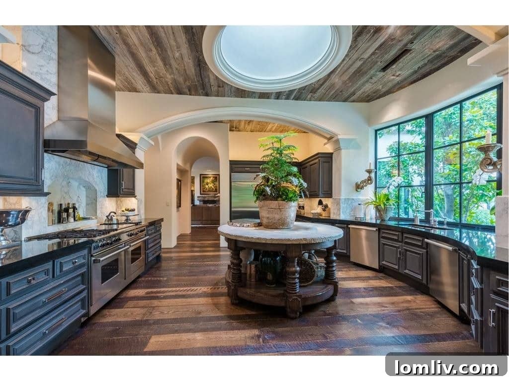 Modern kitchen with wood planked ceiling, round skylight, and unique island design