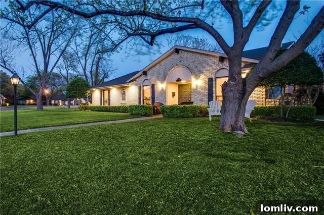 Exterior facade of the renovated ranch home at 12030 Loch Ness Drive