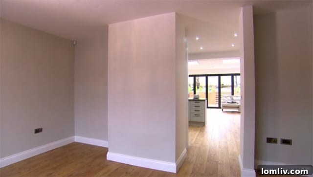 Wall opening extended to the ceiling, connecting spaces seamlessly.