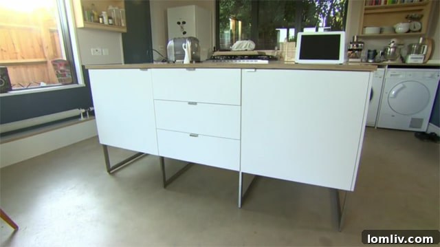 Kitchen cabinetry floating on legs, visually increasing floor space.