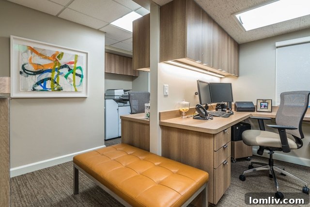 A tastefully decorated hallway featuring local artwork and elegant lighting in the renovated Ebby Halliday office