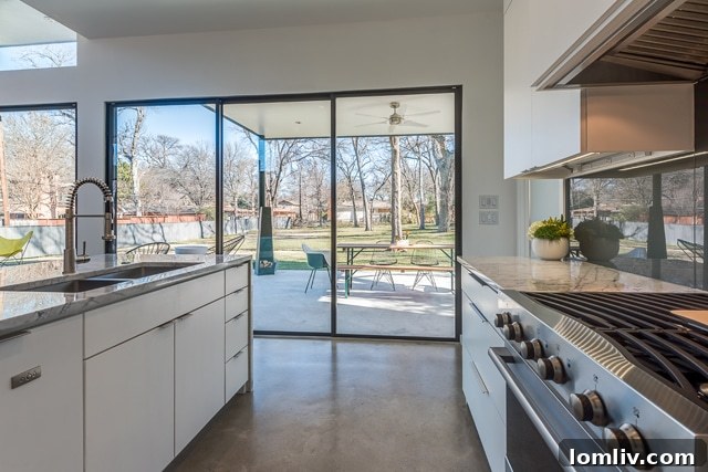 The outdoor entertaining space with a unique custom steel ping pong table, surrounded by lush greenery.