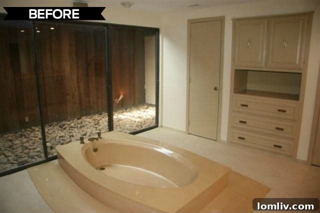 The master bathroom before renovation, featuring a sunken tub and original tiling.