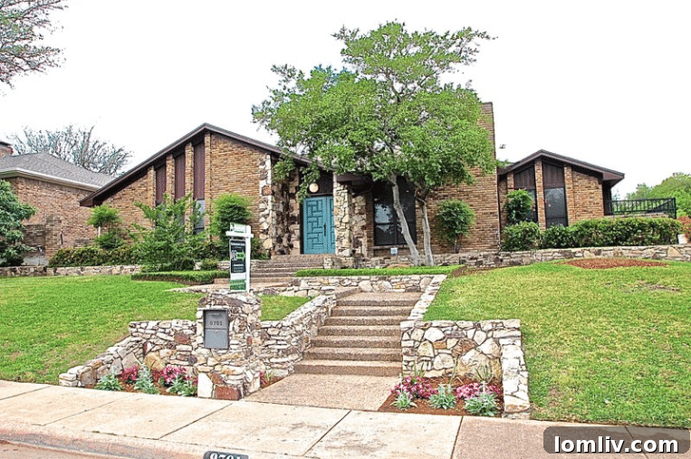Kevin Twitty's Dream Reno Hits Market Wednesday 13 A contemporary living room featuring a custom sectional, Mid-Century Modern furniture, and a vintage record player.