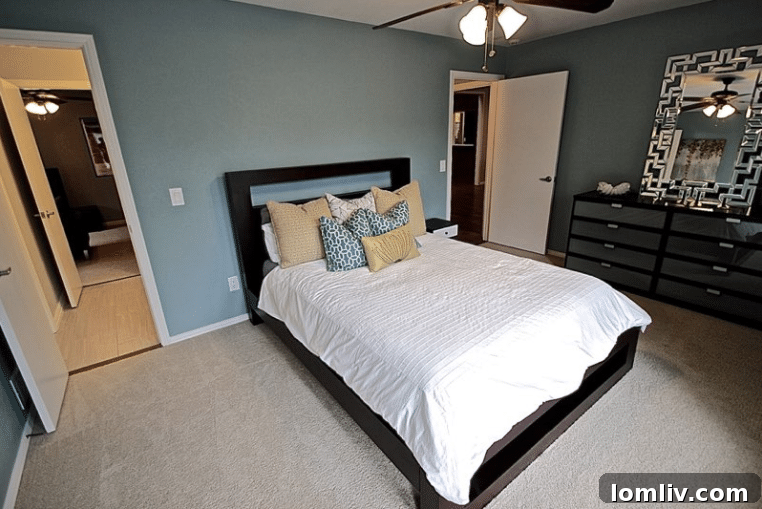 Kevin Twitty's Dream Reno Hits Market Wednesday 47 Front exterior of the home showing the newly painted teal double doors and colorful landscaping.