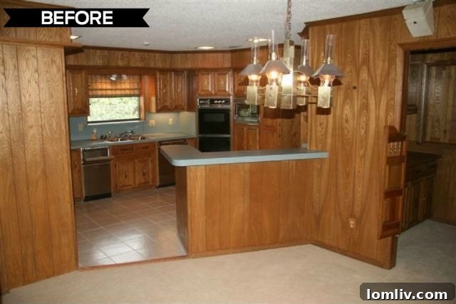 Kevin Twitty's Dream Reno Hits Market Wednesday 9 Original kitchen with wood paneling and outdated appliances, typical of a 1970s design.
