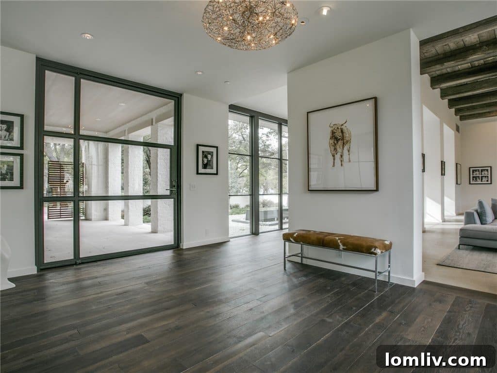 Elegant long hallway with natural light streaming in, showcasing the home's open and airy design.