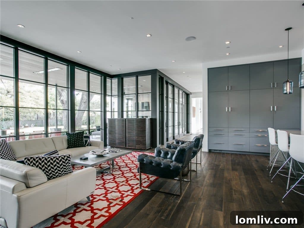 Open concept kitchen and dining area flowing into a comfortable den, overlooking the backyard.