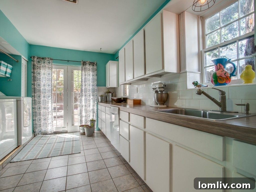 The kitchen at 307 N. Waverly gained significant style with an inexpensive rug, budget-friendly colorful organizer baskets, and cute curtains, enhancing its appeal.