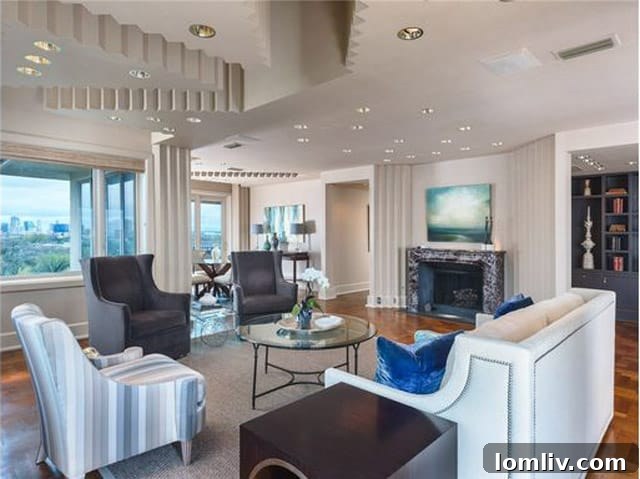 Living space showcasing the dramatic zig-zag ceiling design and expansive windows, with a note on wallpaper condition.