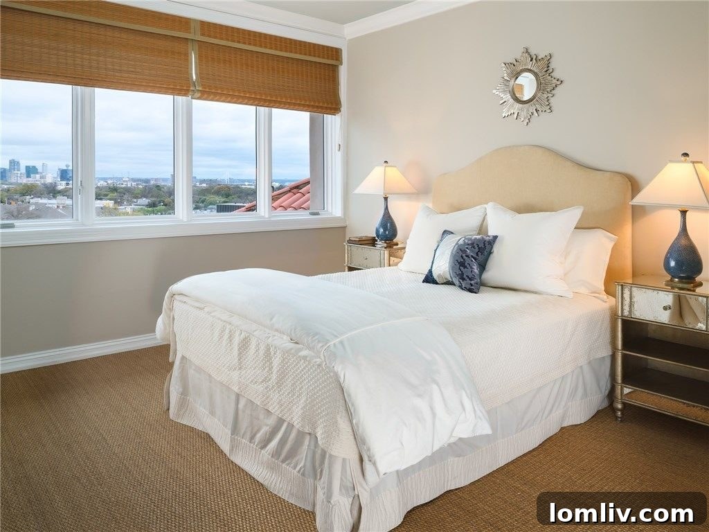 Guest bedroom with large windows offering stunning distant downtown views.