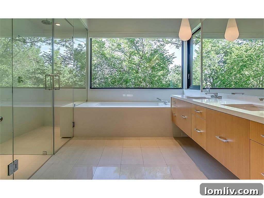 Luxury bathroom with heated floors, steam shower, and tree views