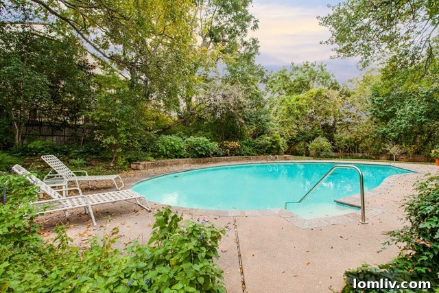 The expansive pool area at 3756 Armstrong Ave, set on 0.84 acres of land with terraced retaining walls.