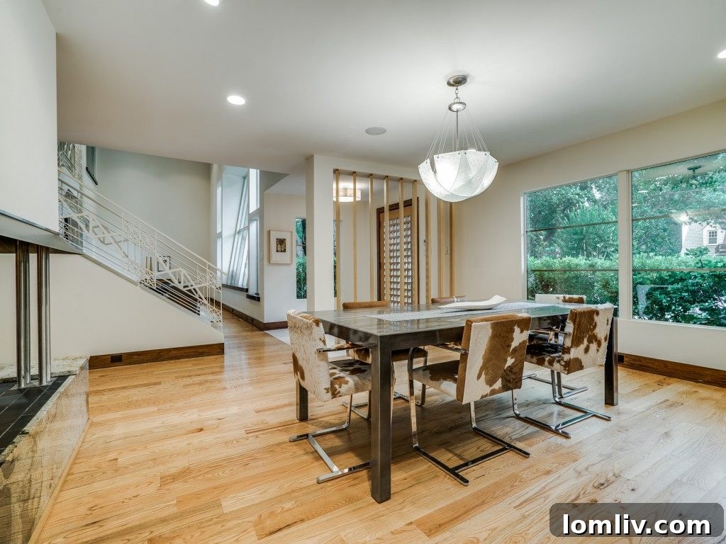 Spacious main living area featuring a central fireplace and red oak flooring