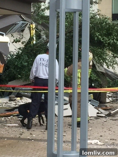Emergency personnel inspect the damaged facade of Taylor Luxury Apartments after the reported incident