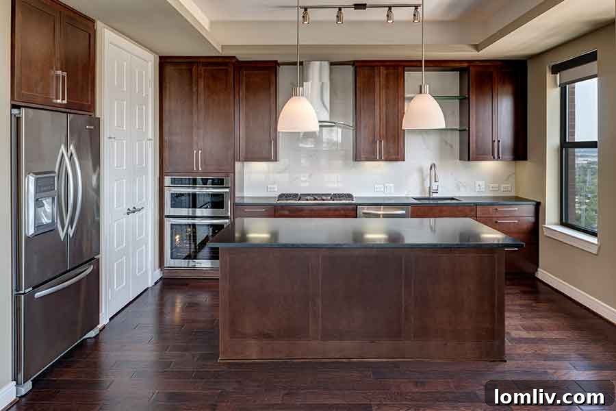 Luxurious bedroom suite with large windows and city views at Taylor Luxury Apartments