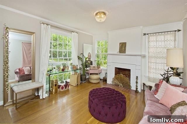 Formal dining room with captivating designer wallpaper and a large window providing ample natural light.